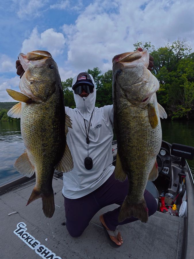 Angler holding up two trophy largemouth bass