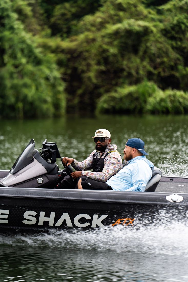 Running the bass boat across the lake with clients aboard